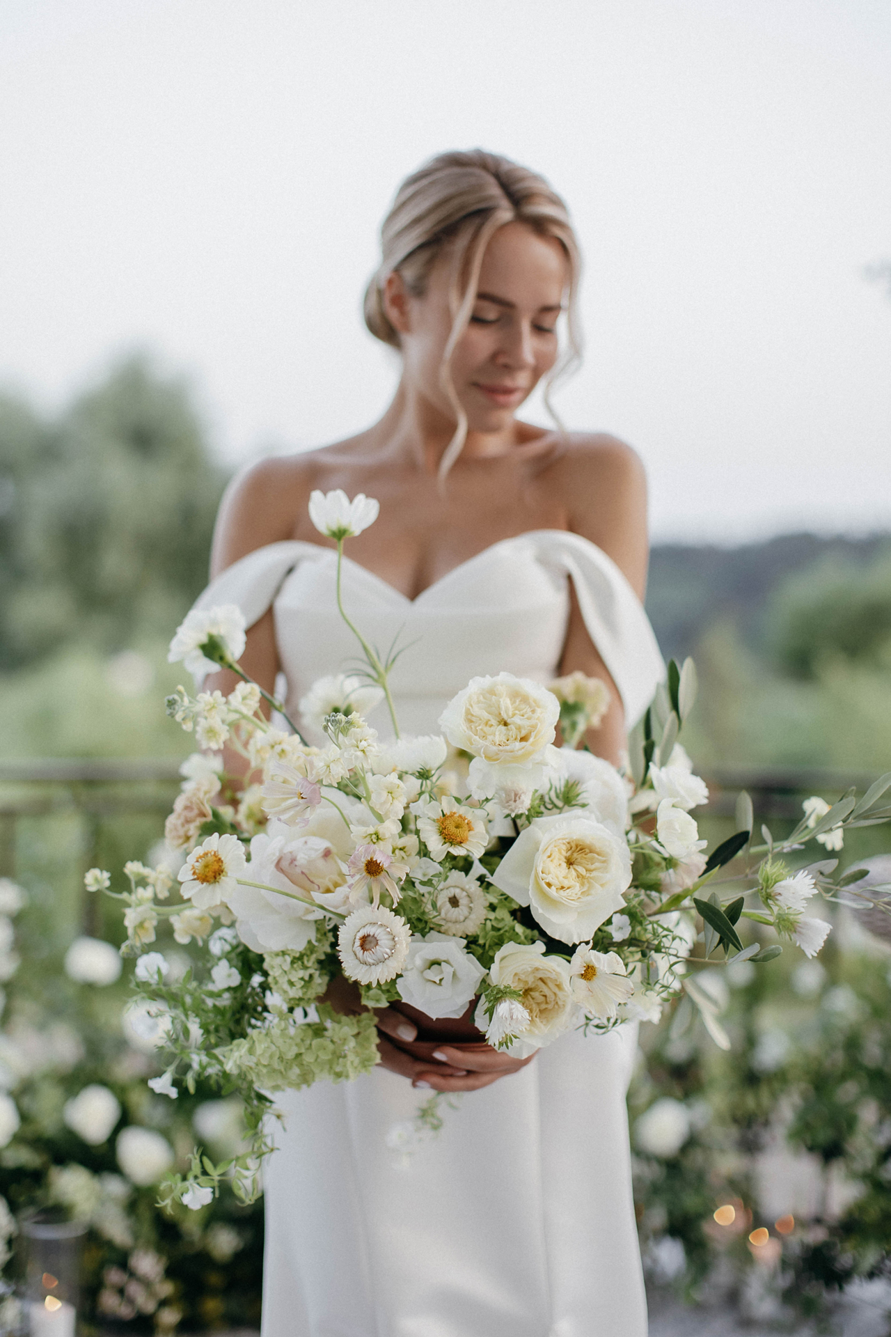 Bride holding a pastel bouquet, hair styled by Iryna Pasechnik