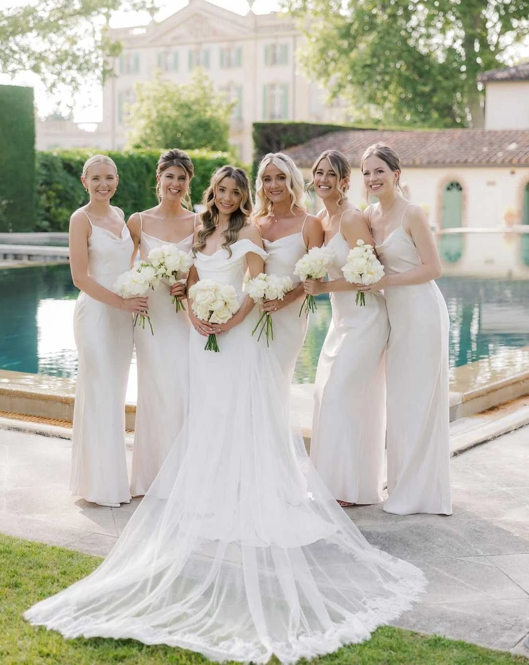 Bride with her bridesmaids by the pool
